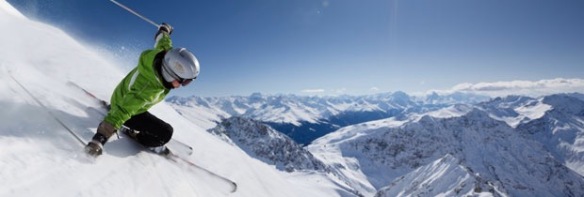 Skier with sun and mountains